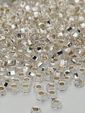 a close-up view of numerous clear glass beads scattered across a surface.