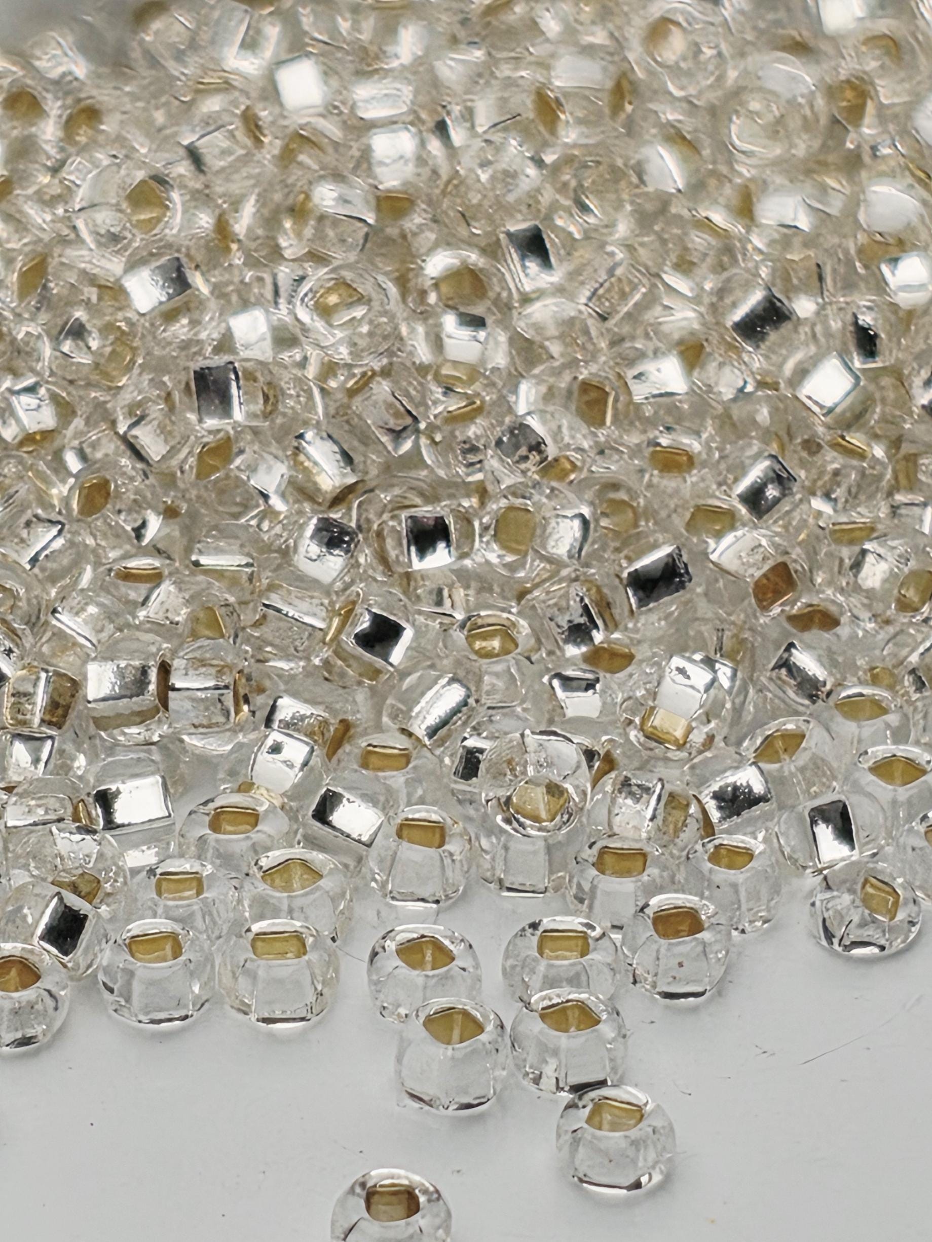 a close-up view of numerous clear glass beads scattered across a surface.