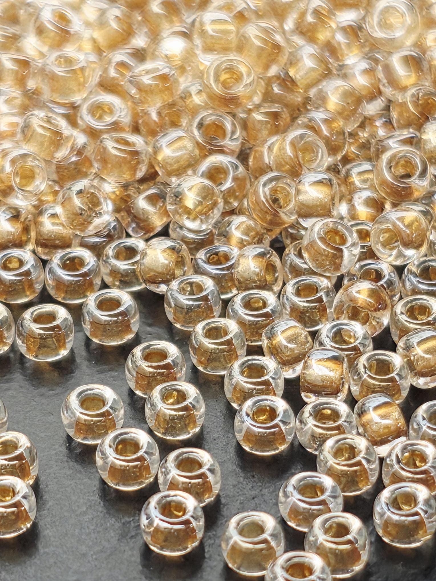 a close-up view of numerous small, clear glass beads scattered across a surface.