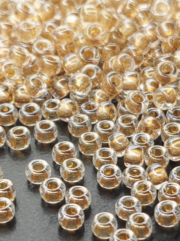 a close-up view of numerous small, clear glass beads scattered across a surface.