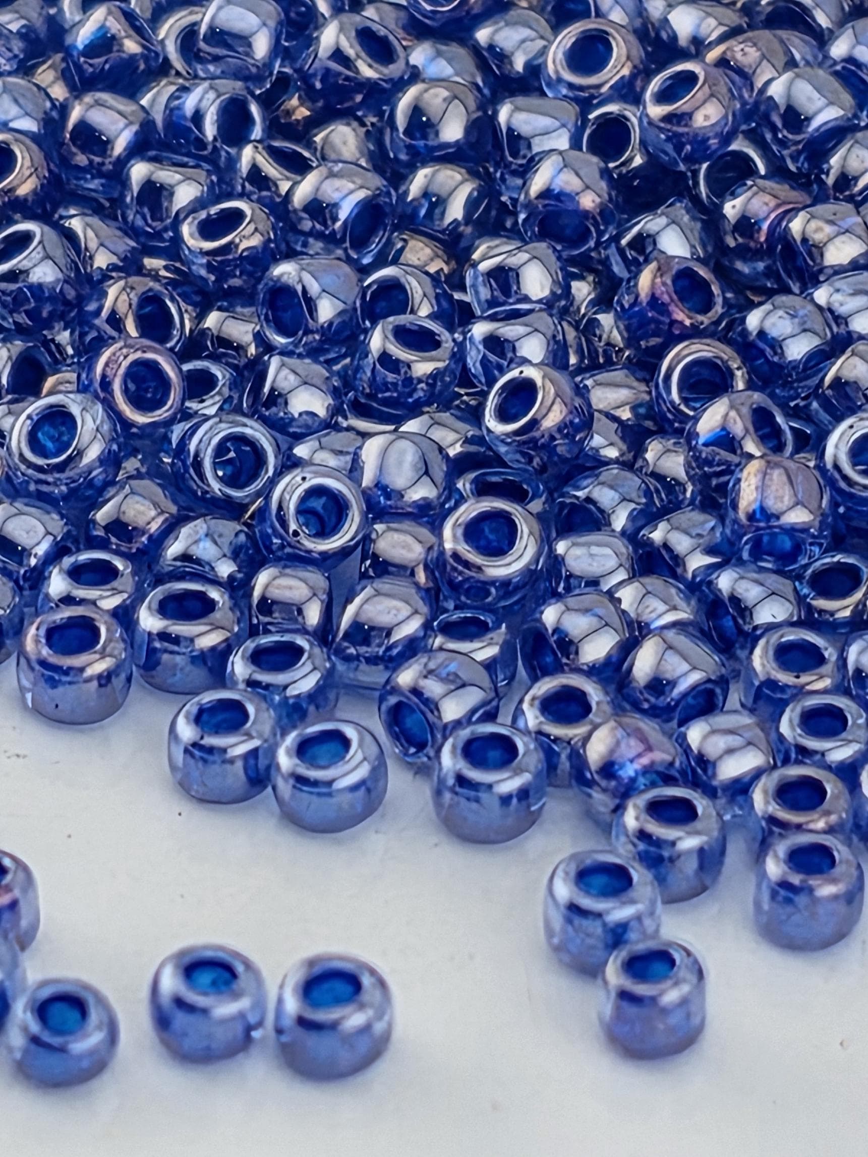 a close-up view of numerous blue glass beads scattered across a surface.