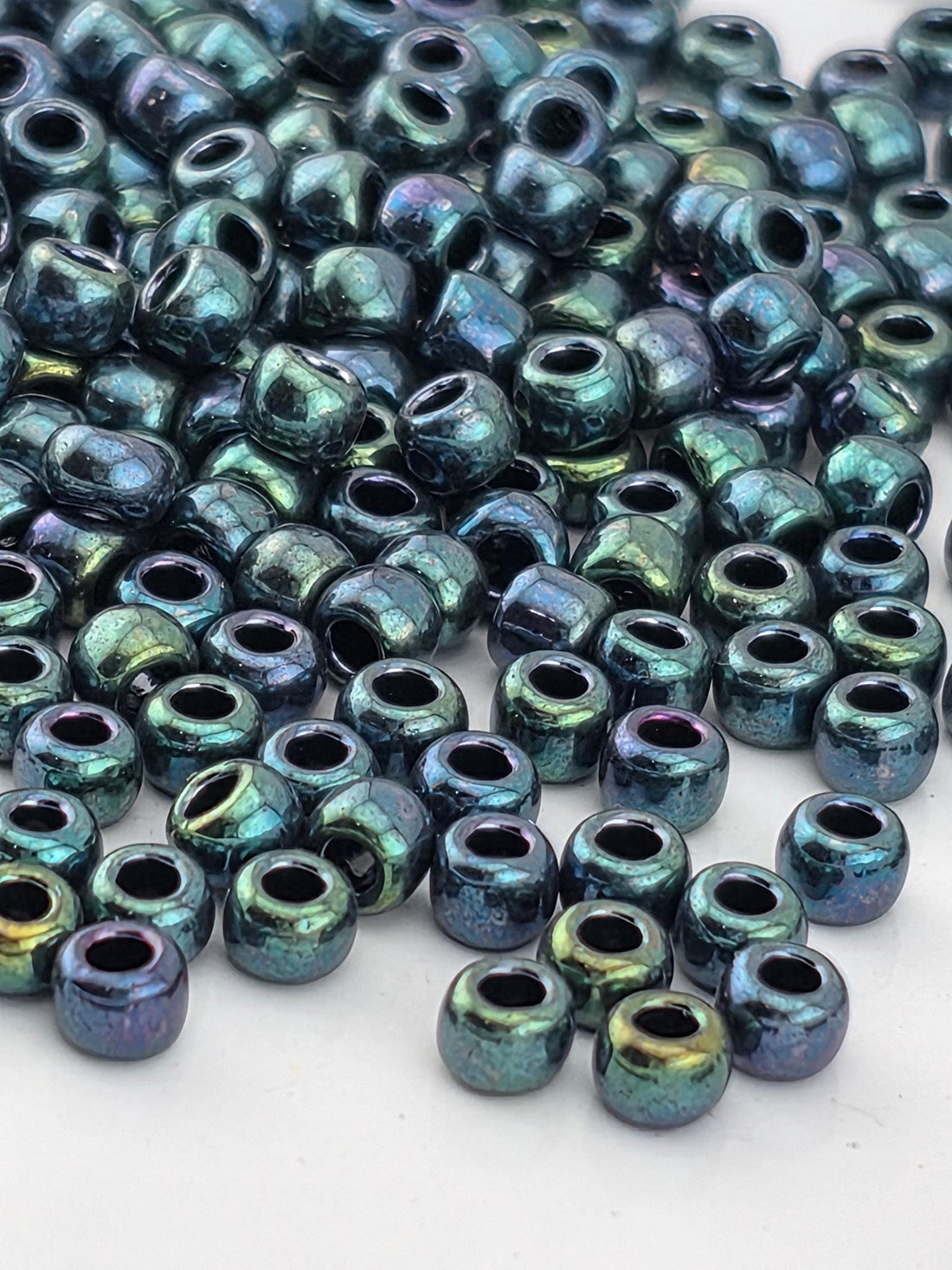 a close-up view of numerous multicolored beads scattered on a surface.