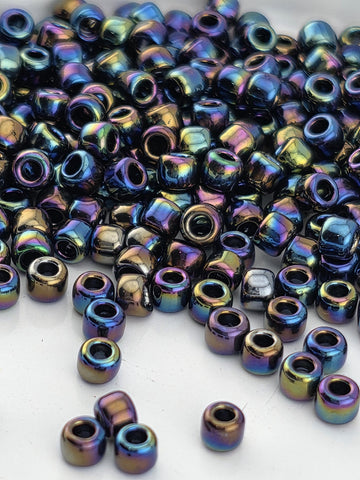 a collection of multicolored glass beads scattered on a white surface.