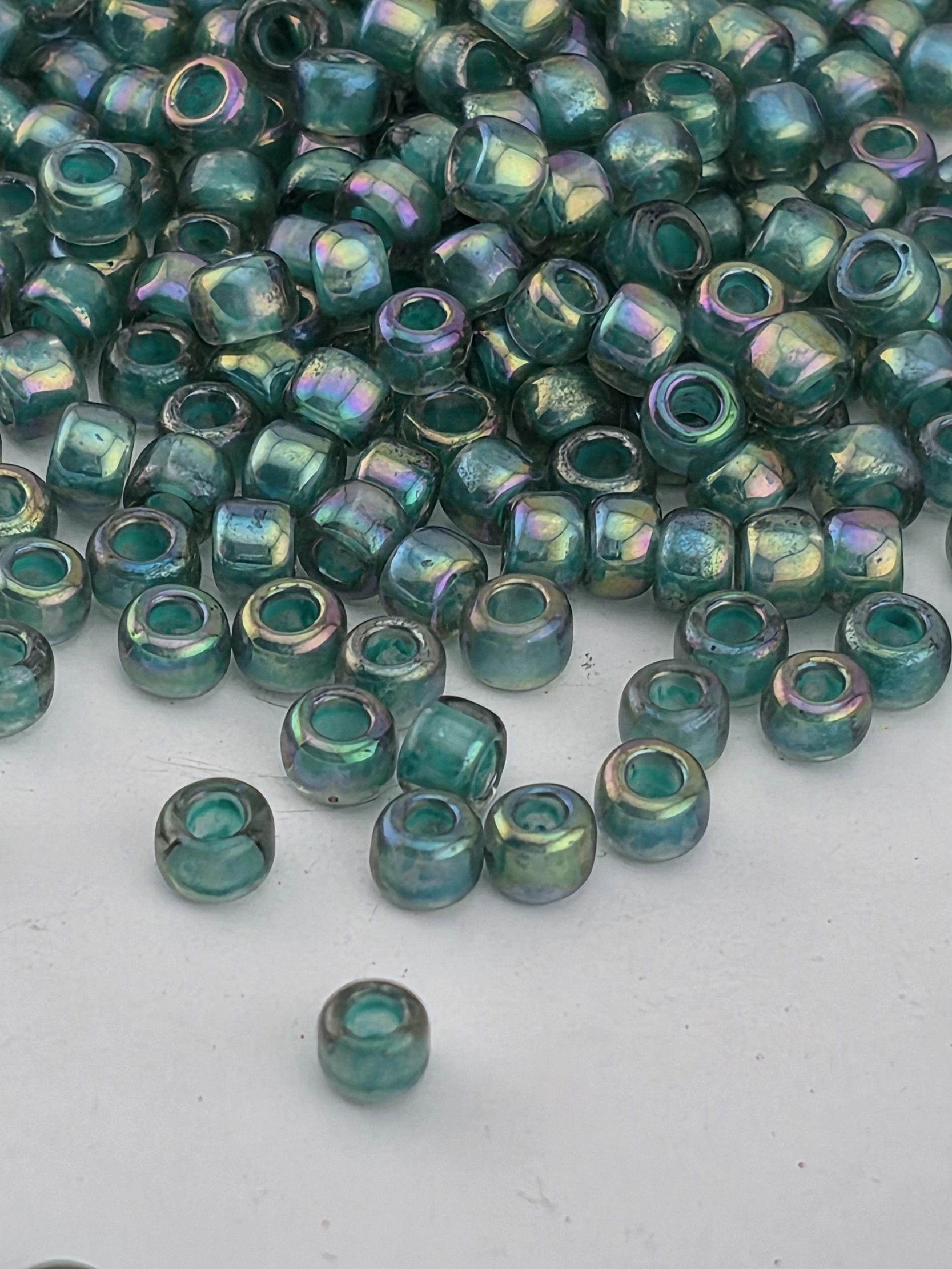 A pile of multicolored glass beads on a white surface.