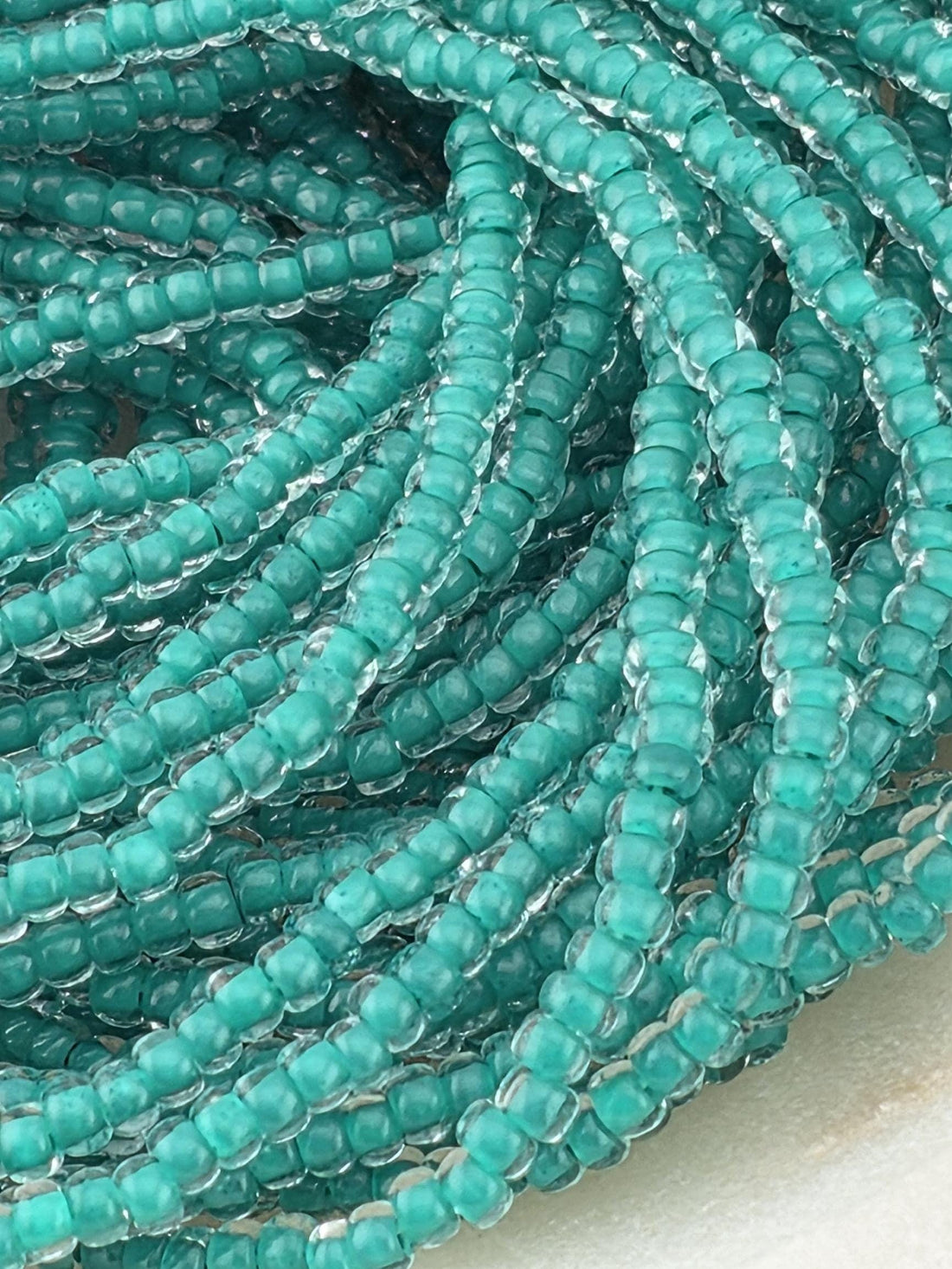 Transparent Terra Intensive Crystal Lined Sea Green | Size 11 | Half-Hank (12" 6-String) | Preciosa-Ornela Glass Seed Beads