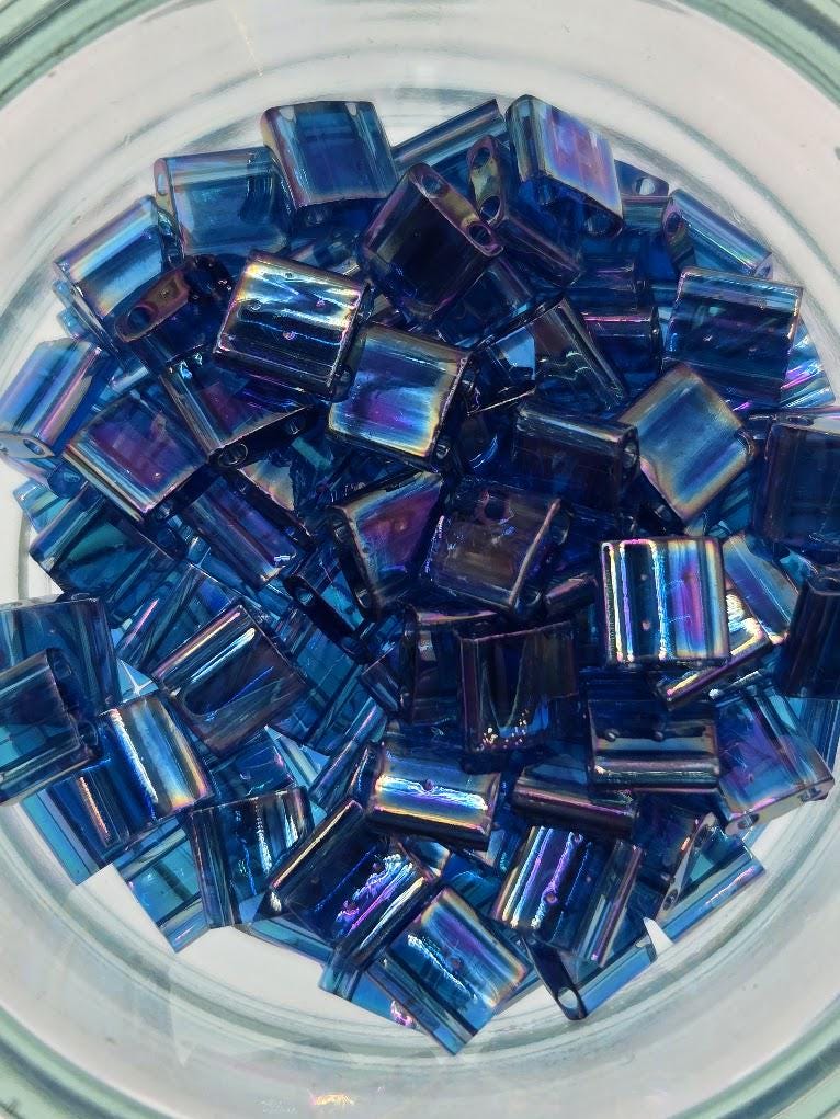 numerous small, square-shaped blue beads arranged in a circular pattern.