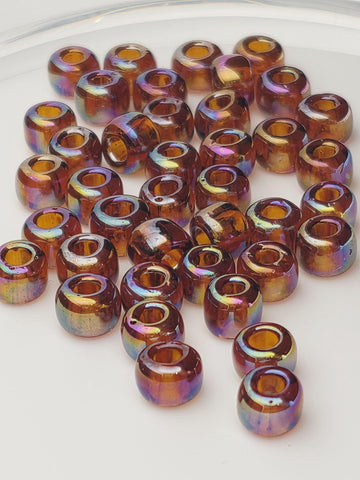a collection of multicolored glass beads scattered on a white surface.