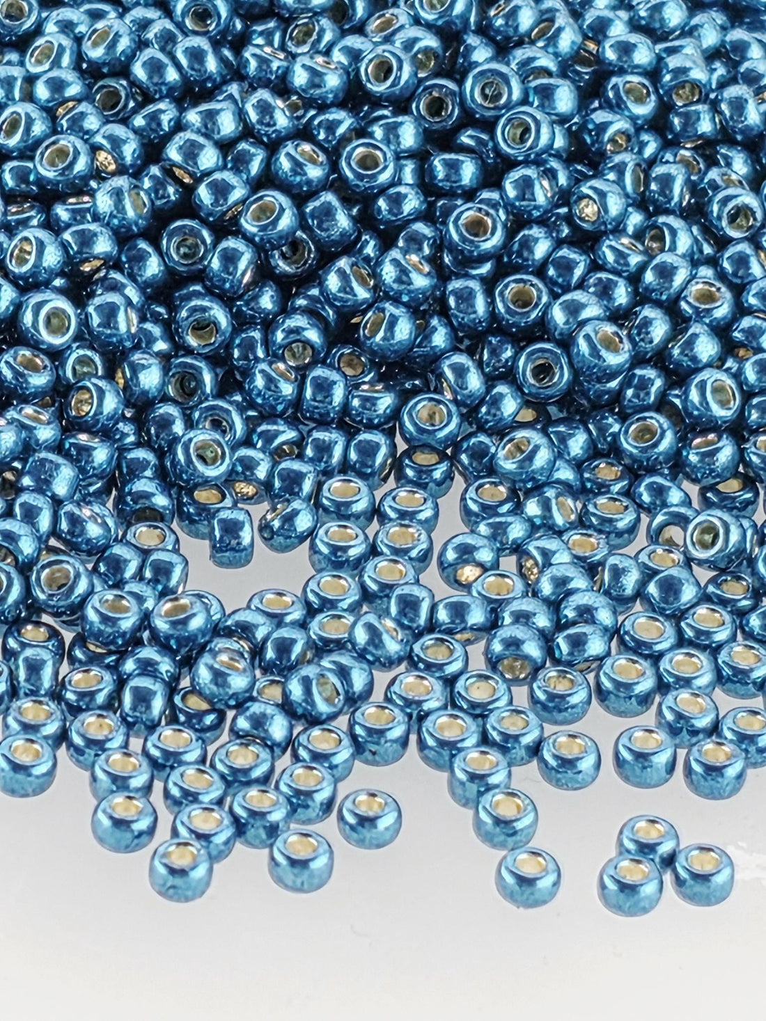 a close-up view of numerous blue beads scattered across a surface.