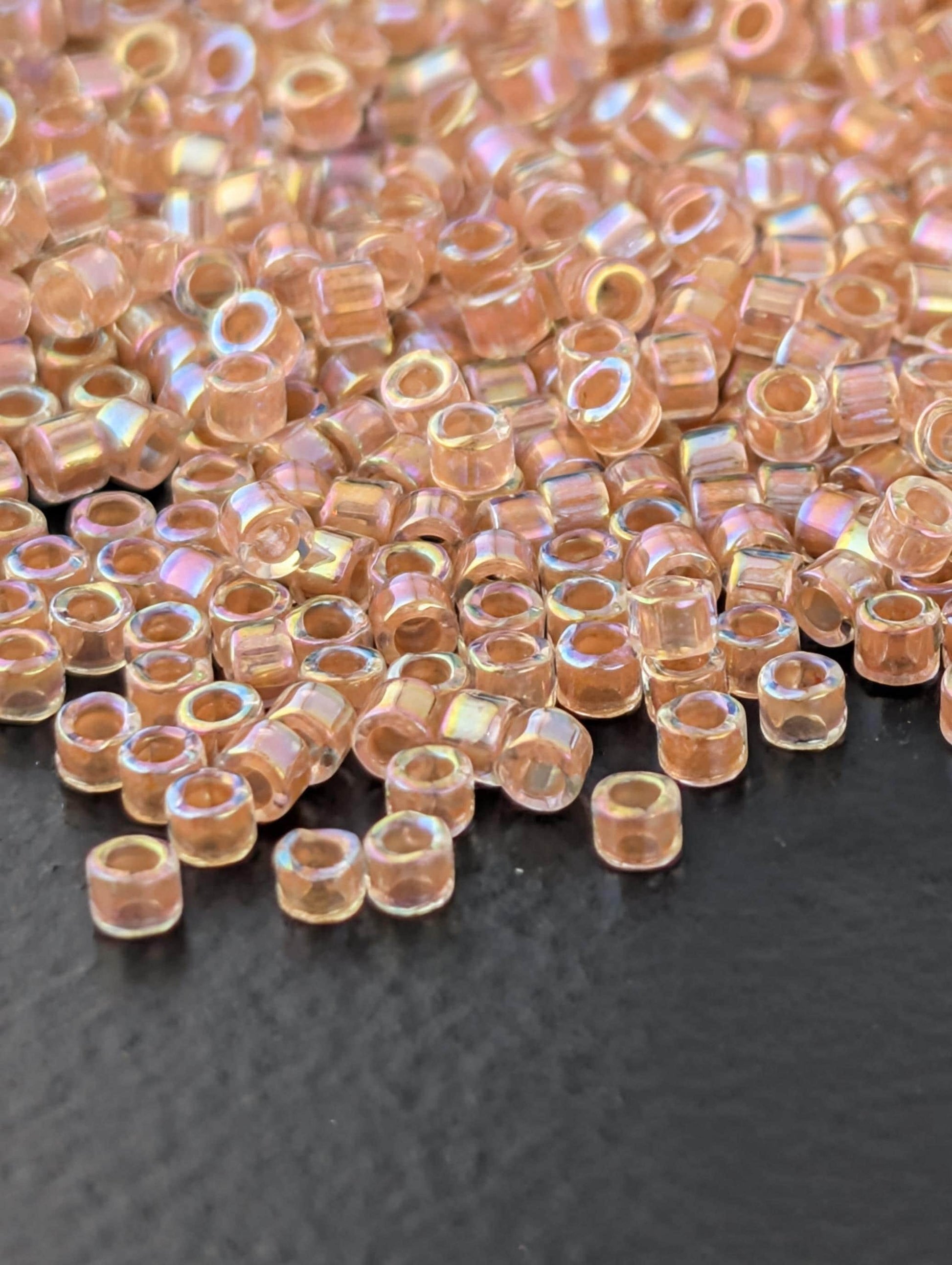 DB0054:Crystal/Peachy Gold Inside Color Lined Rainbow | Size 11/0 | 7g