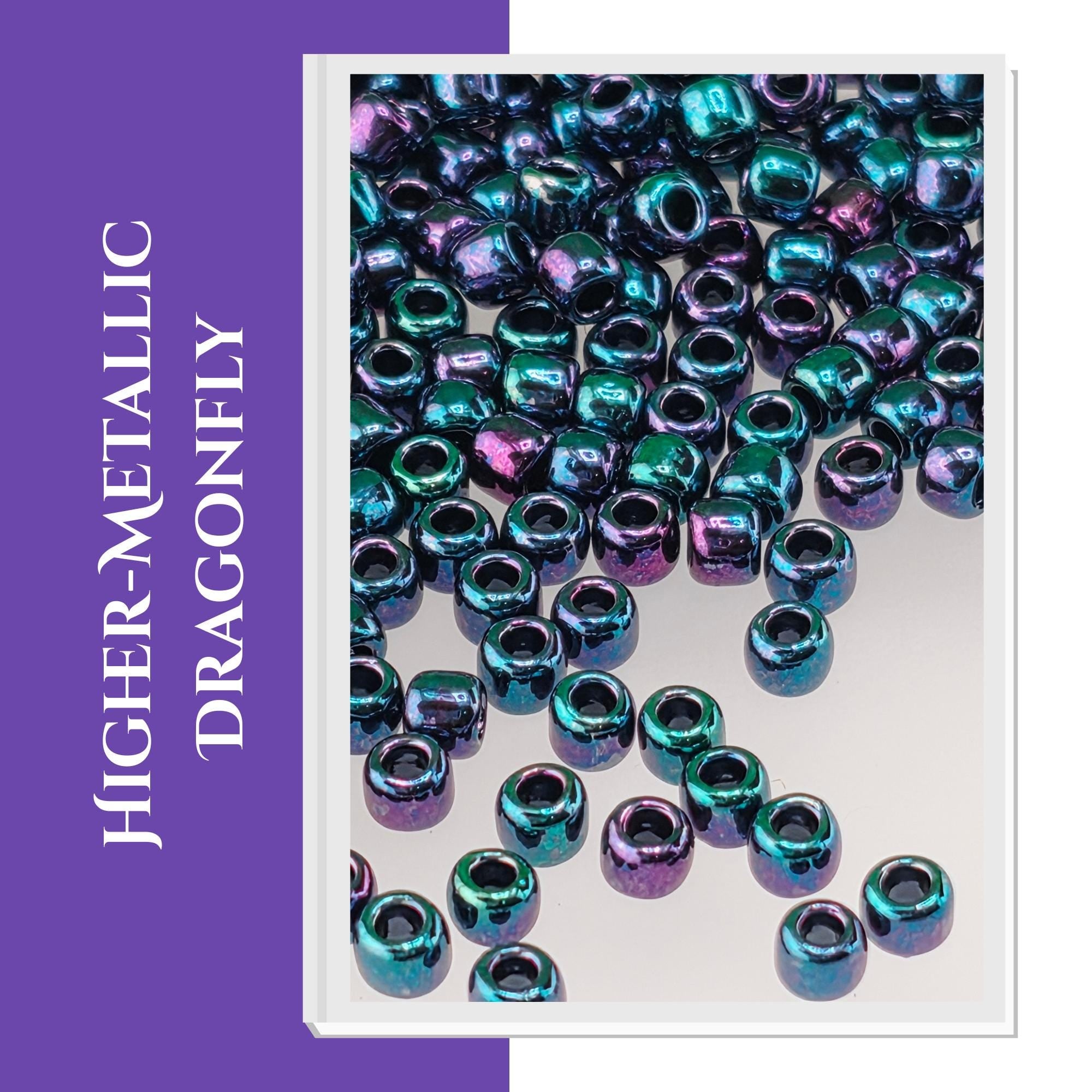 a collection of metallic beads in various shades of blue, green, and purple, scattered across a white background.