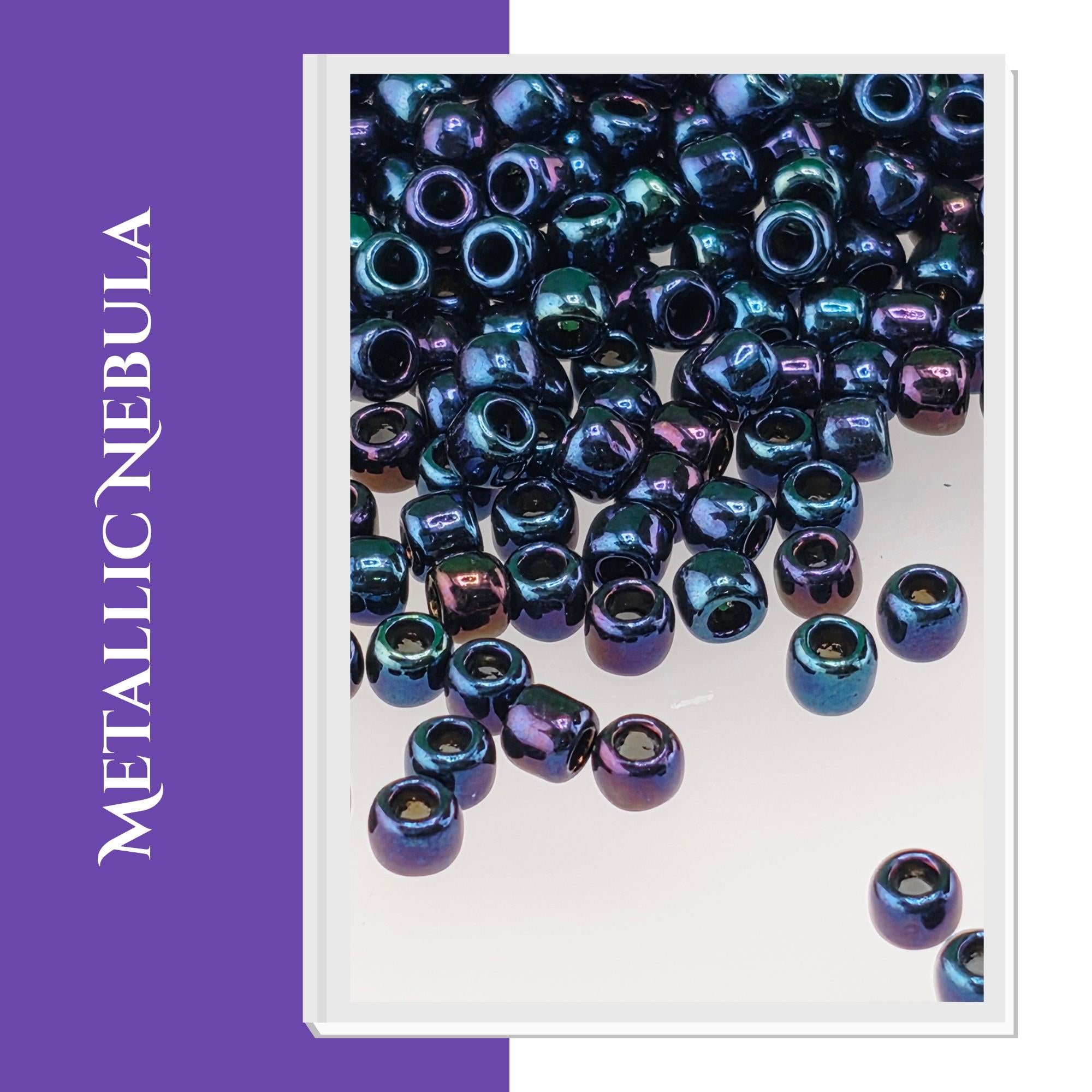 a collection of metallic beads in various shades of blue and purple, scattered across a white background.