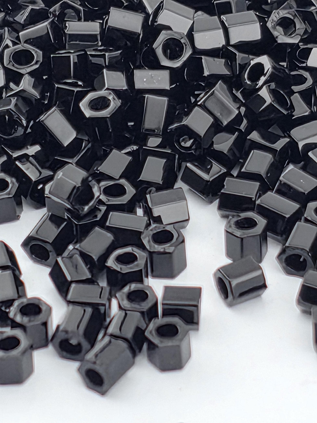 numerous black hexagonal objects scattered across a white background.