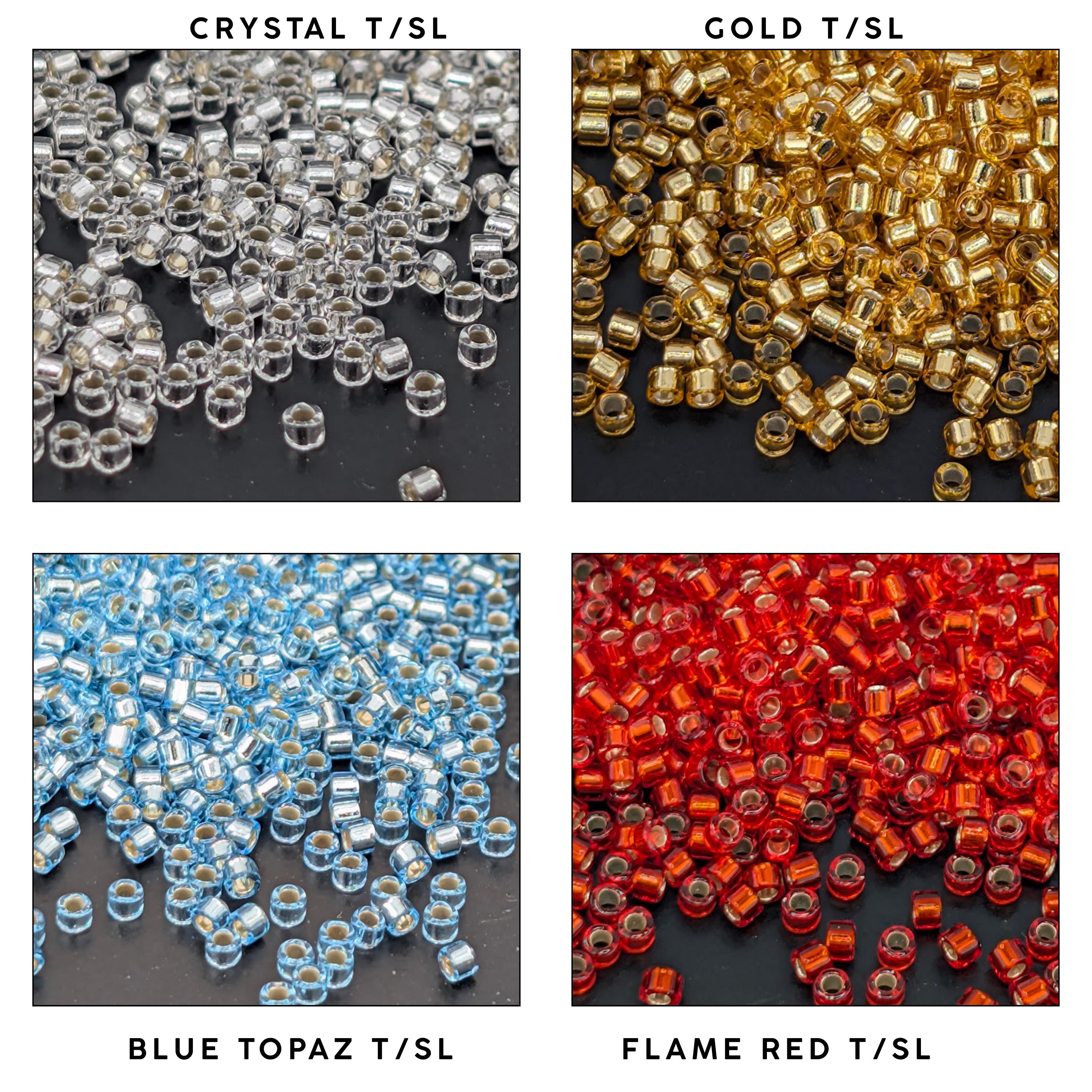 four different types of beads or materials, each with a distinct color and texture: crystal, gold, blue, and red.