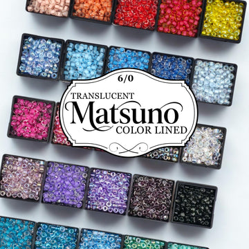 a collection of colorful beads arranged in various containers, with a label in the center that reads "TRANSLUCENT MATSUNO COLOR LINED".