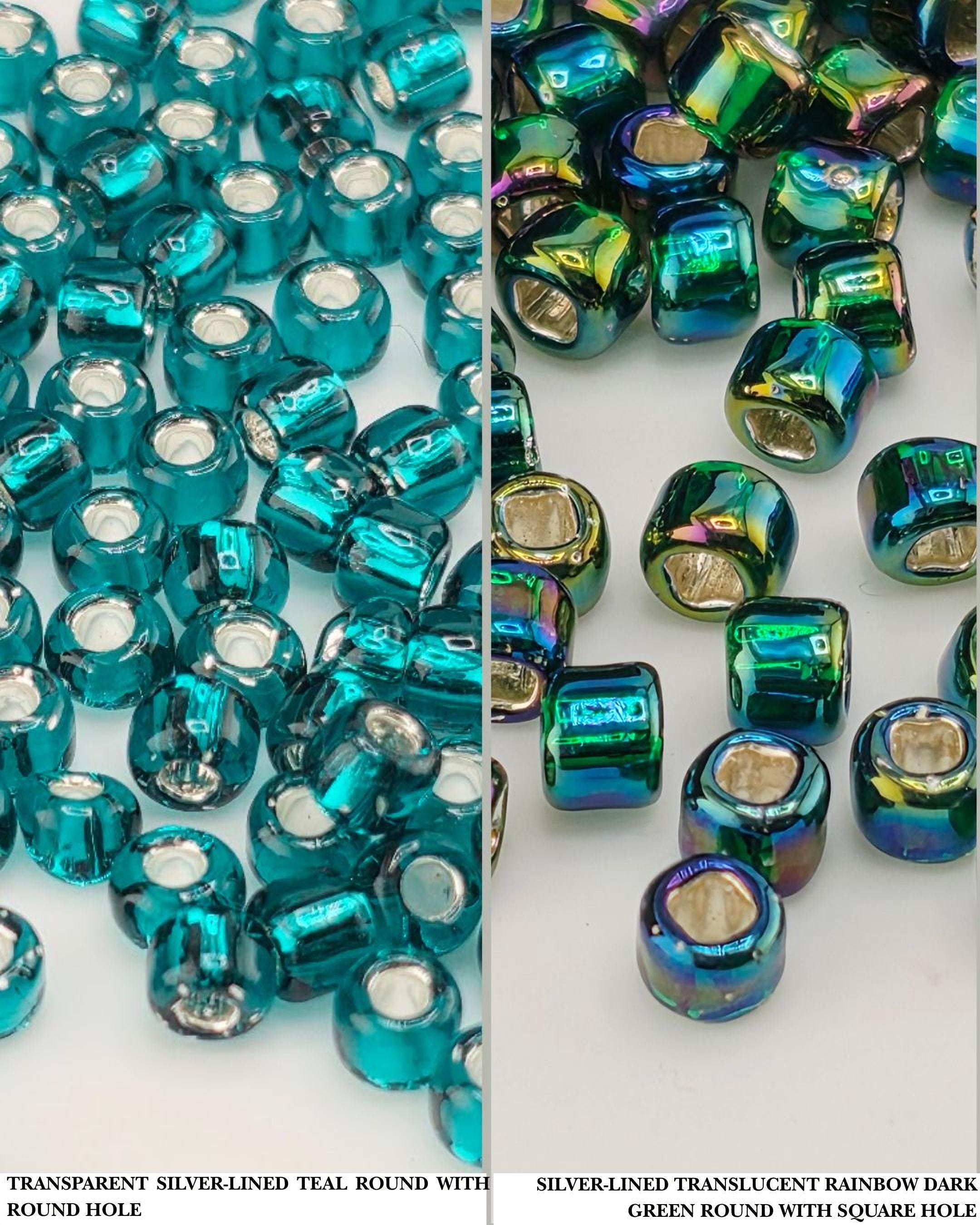 two sets of round beads, one with a transparent silver lining and the other with a transparent rainbow-colored lining. The beads are arranged in two rows, with the top row containing blue beads and the bottom row containing green beads.