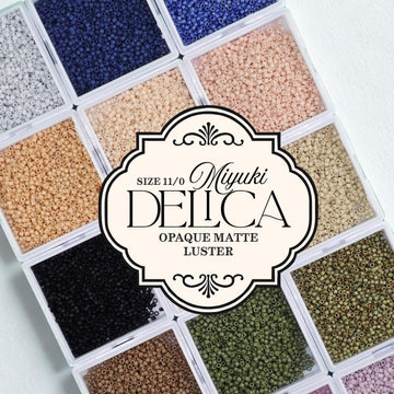 a collection of colorful beads in various sizes, arranged in a grid-like pattern.