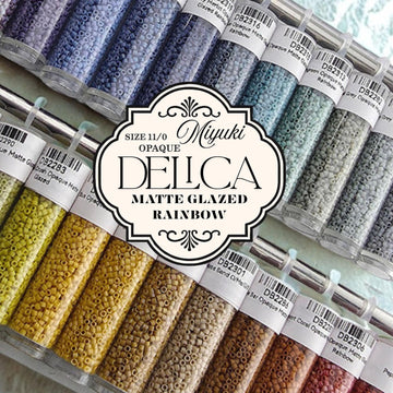 a collection of colorful beads in various sizes and colors, arranged in rows and columns. The beads are labeled with text indicating their sizes and colors, such as "Size 11/0", "OPAQUE", "DELLCA", "MATTE GLAZED", and "RAINBOW".
