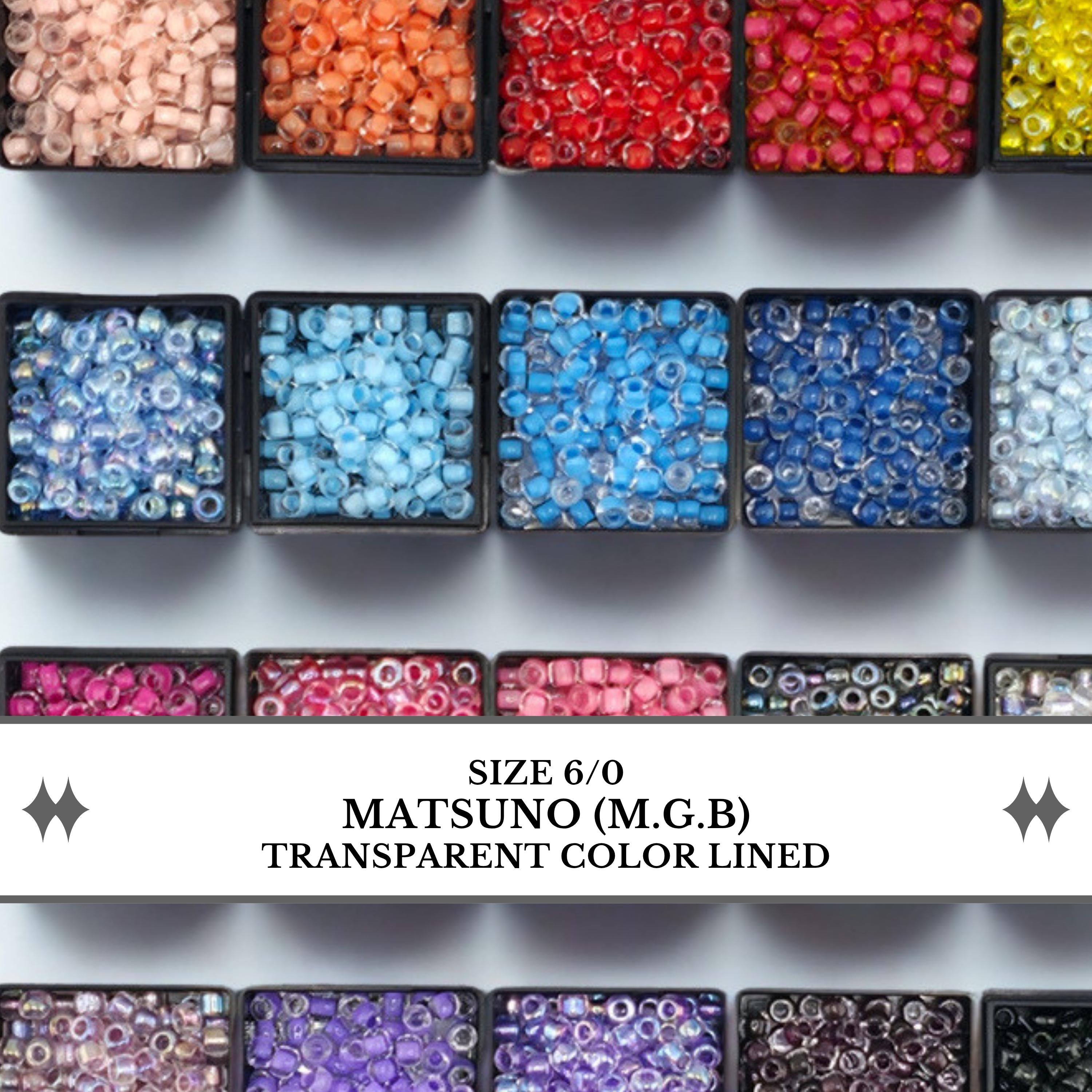 a collection of various colored beads, including pink, blue, and red, arranged in multiple rows.