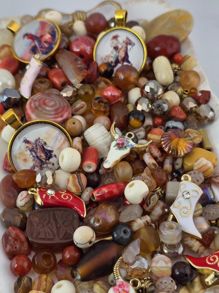 The image is a collage of various beads, charms, and trinkets, including pendants, charms, and beads in different colors and shapes.