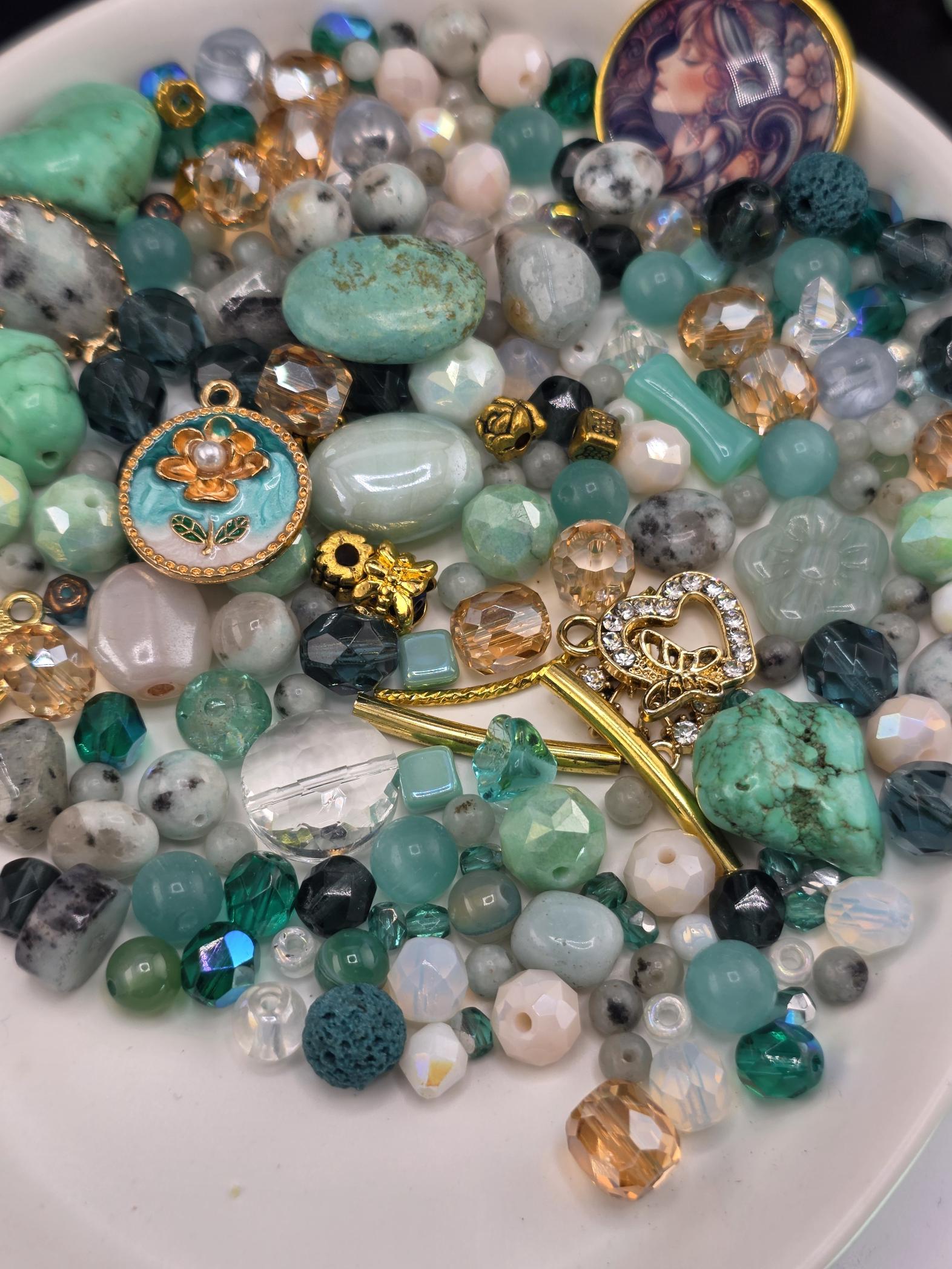A plate filled with a variety of colorful beads, charms, and other decorative items.