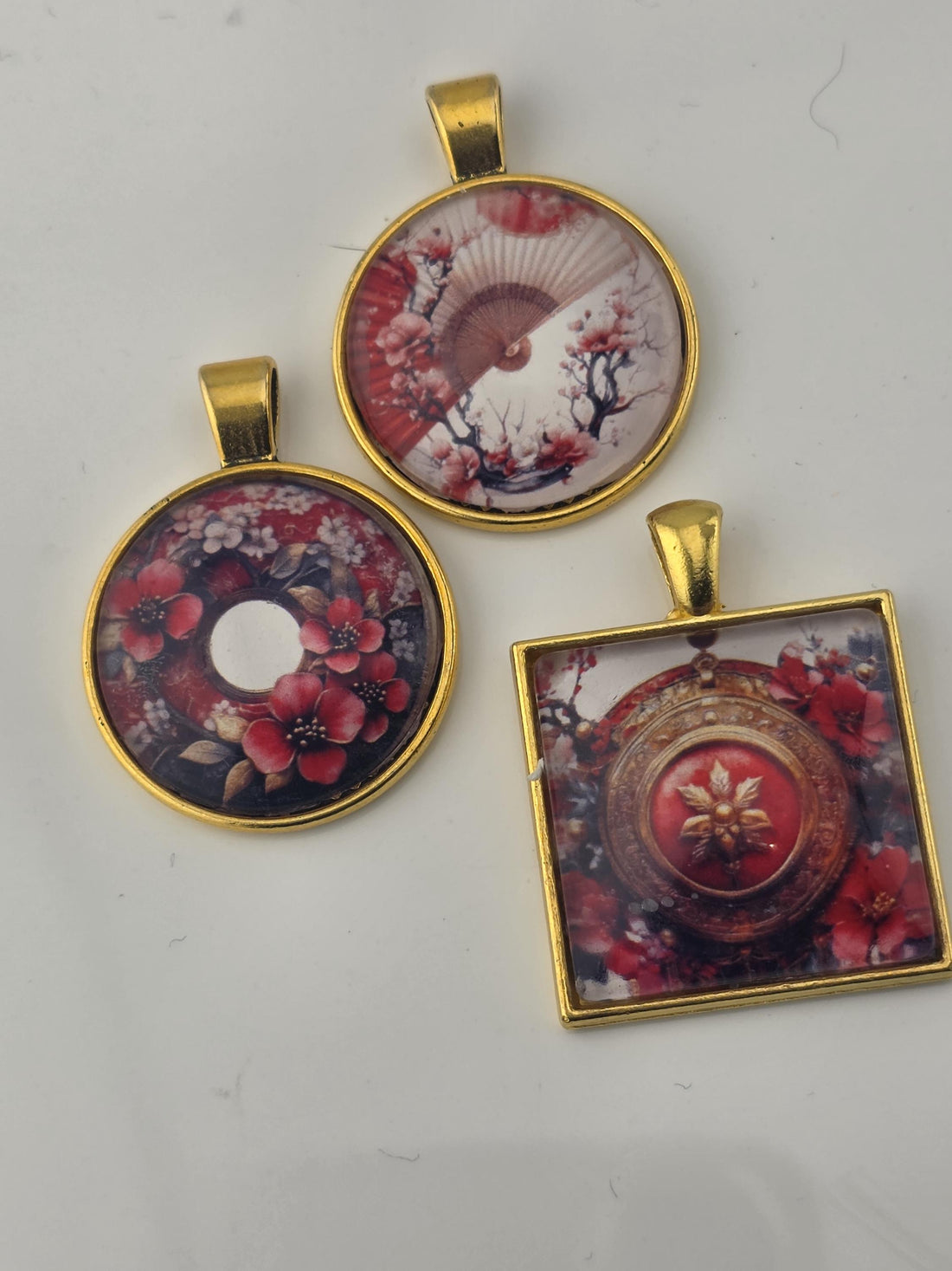 The image is a collage of various red and gold jewelry pieces, including beads, charms, and pendants, arranged in a visually appealing manner.
