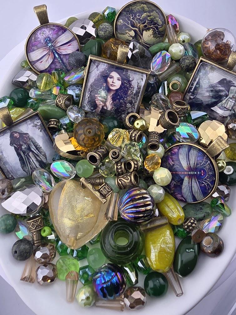 The image is a collage of various colorful beads, charms, and pendants, including gemstones, glass beads, and metal pieces, arranged on a white surface.