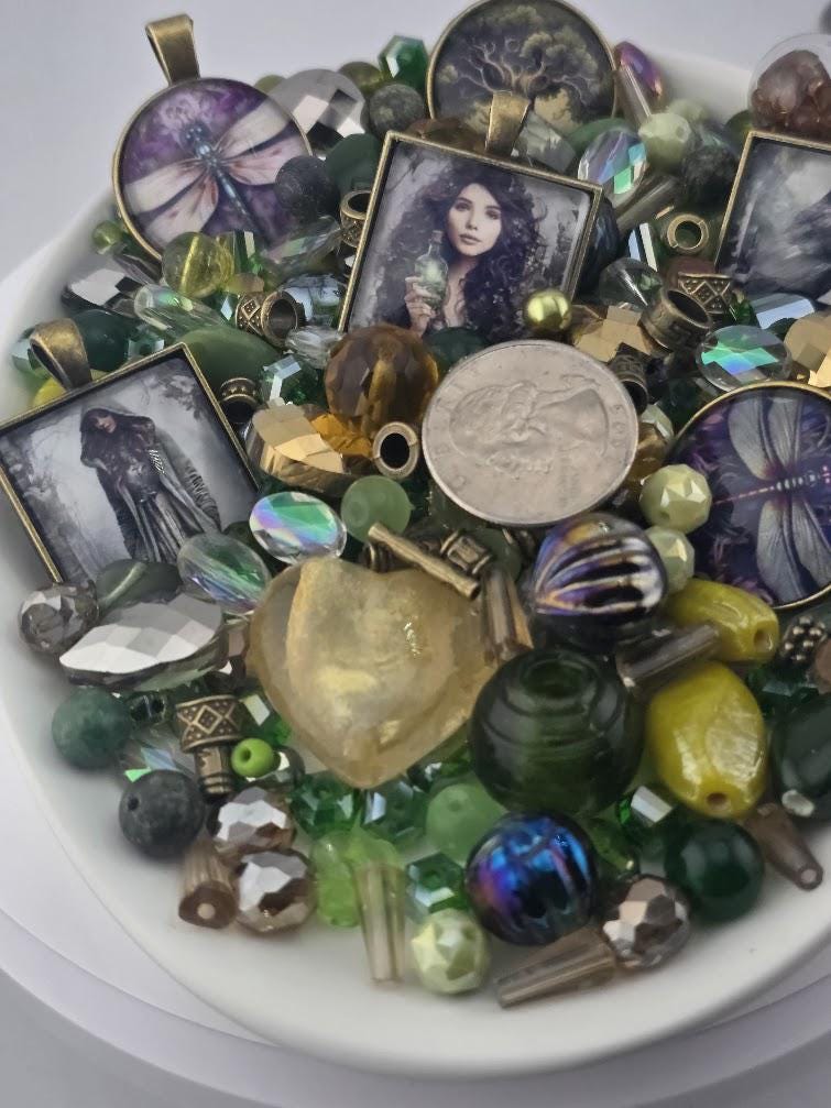 The image is a collage of various colorful beads, coins, and other small objects arranged on a white surface.
