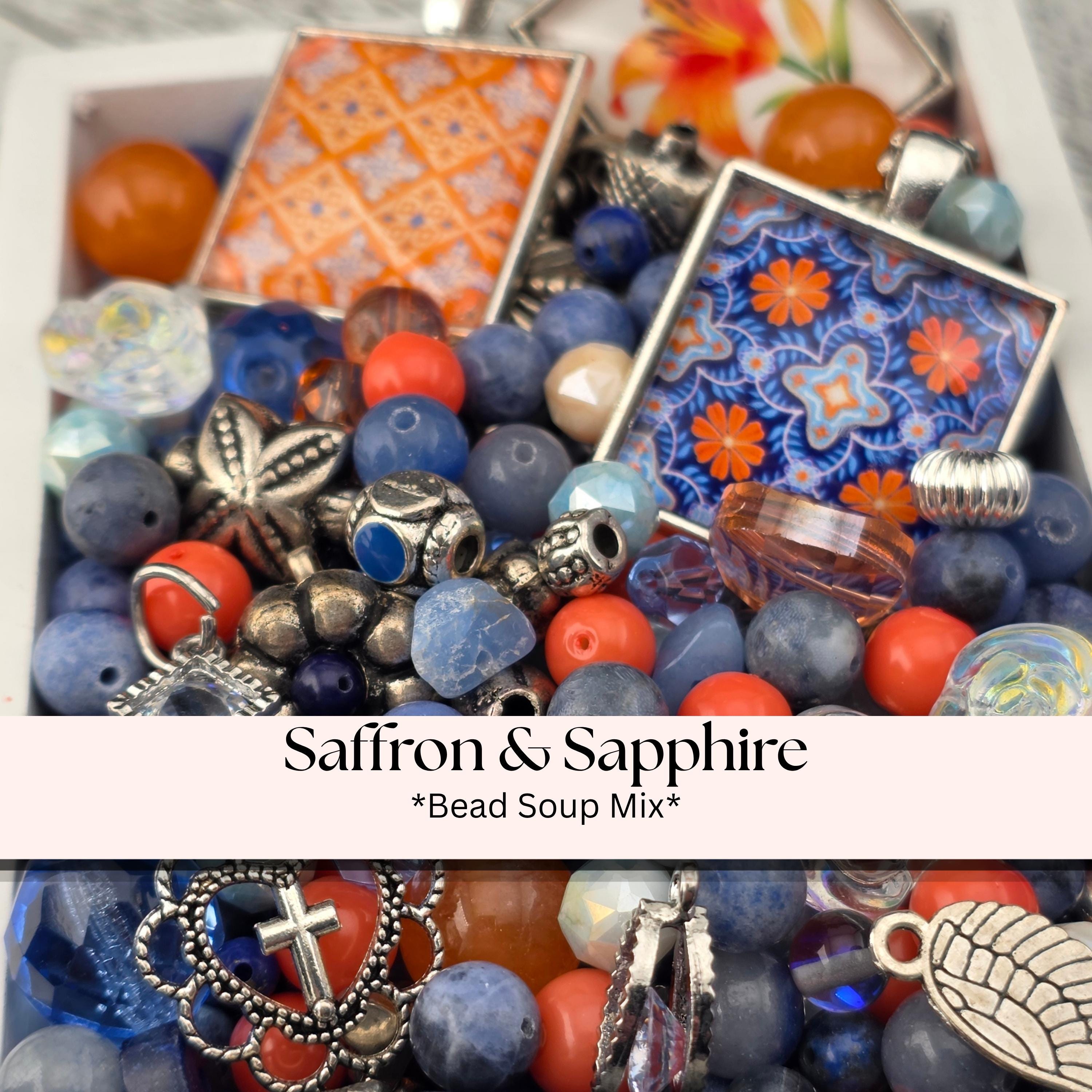 A collection of colorful beads, charms, and other decorative items, including blue, orange, and silver elements, arranged in a visually appealing manner.