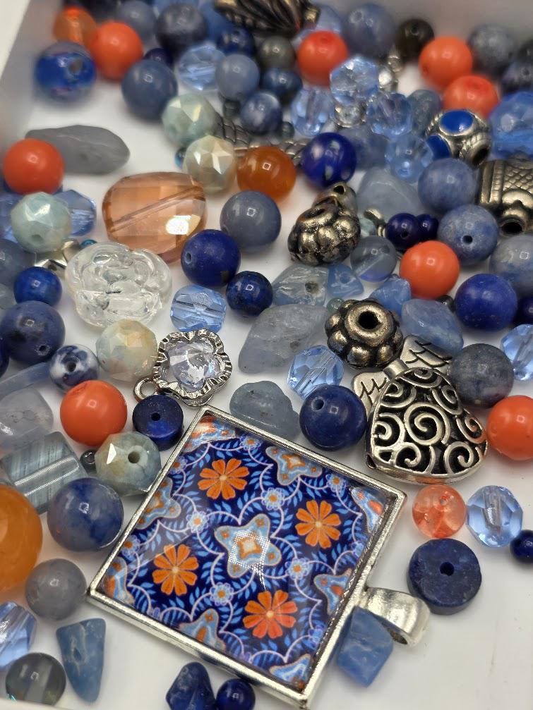 a variety of colorful beads, charms, and pendants scattered across a surface, creating a vibrant and visually appealing display.