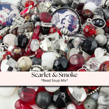 A collection of various beads, charms, and trinkets, including red, black, silver, and white beads, as well as some with a portrait of a woman on them.