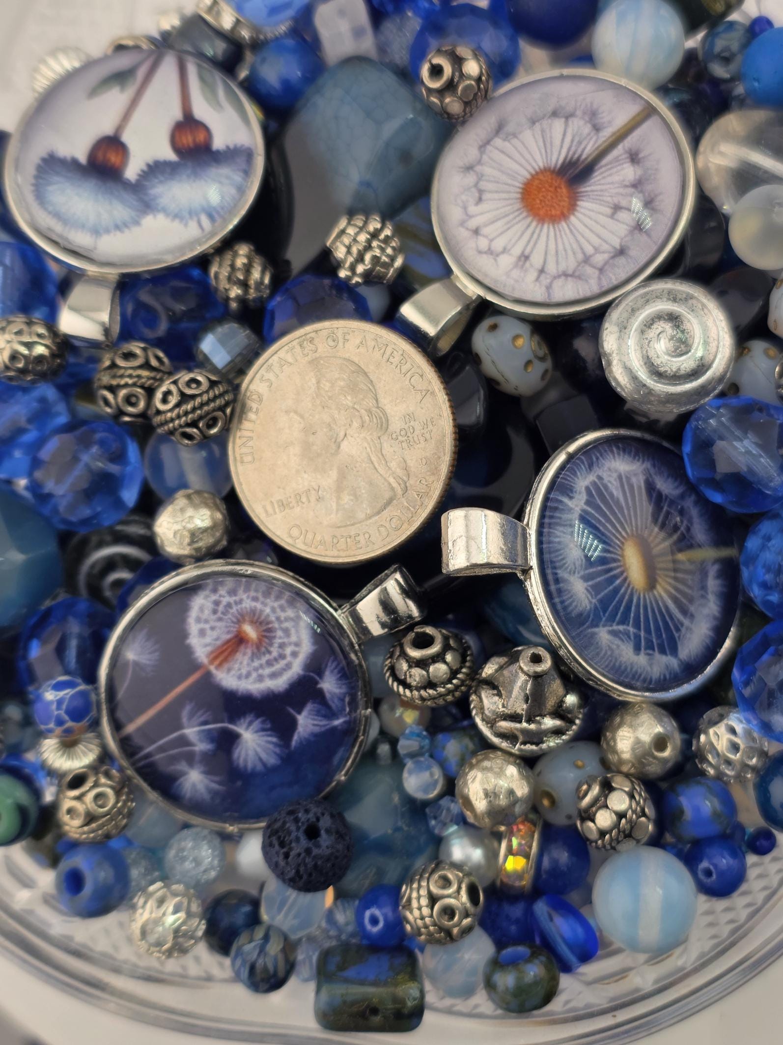 a variety of colorful beads, coins, and other small objects arranged in a visually appealing manner.
