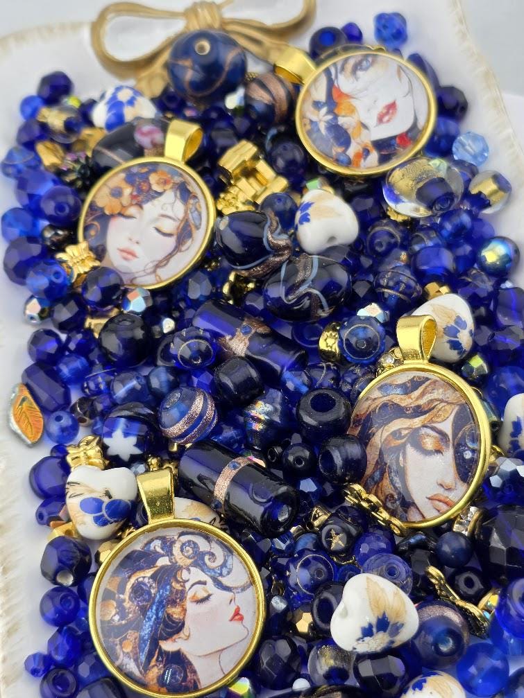The image is a collection of various blue and gold jewelry pieces, including pendants, earrings, and beads, arranged on a surface.