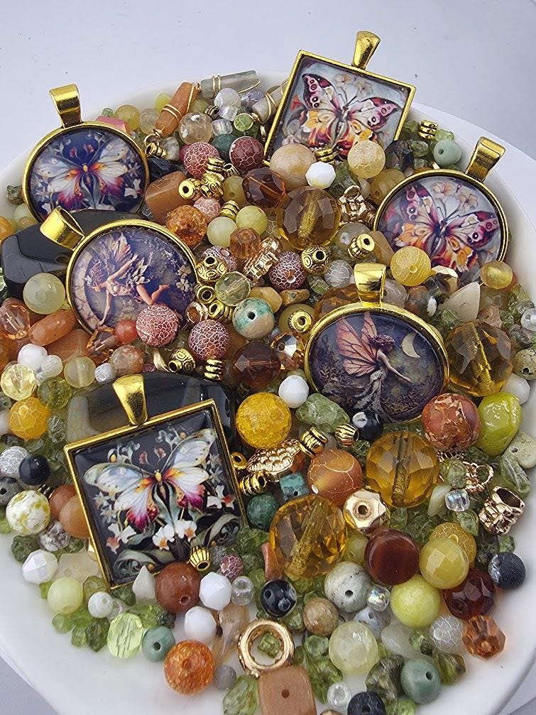The image is a collection of various colorful beads, charms, and pendants, including butterfly-themed designs, arranged on a white surface.