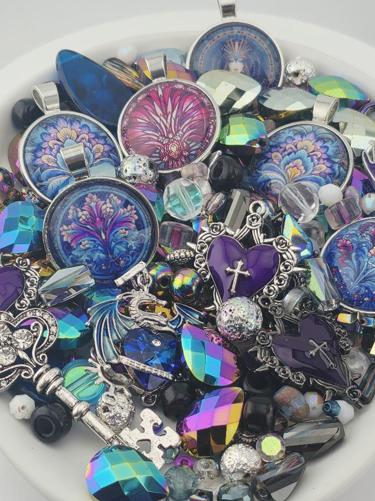 The image is a collection of various colorful and ornate jewelry pieces, including pendants, charms, and beads, arranged in a visually appealing manner.