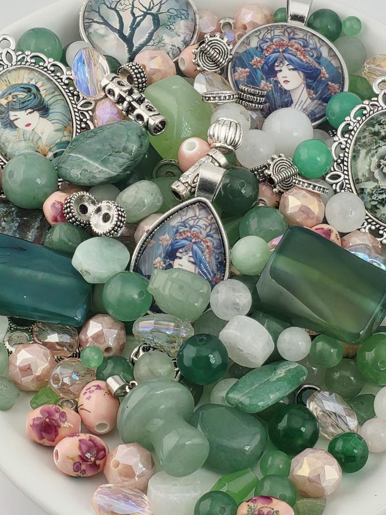 The image is a collection of various beads, charms, and other decorative items, including pendants and charms, arranged in a bowl or container.