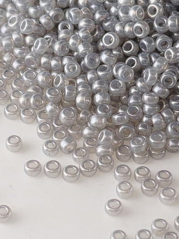 a large pile of small, clear beads scattered across a surface.