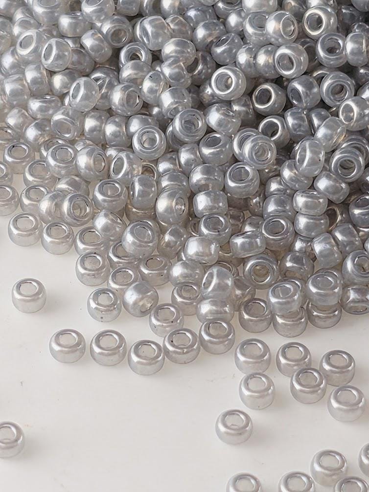 a large pile of small, clear beads scattered across a surface.