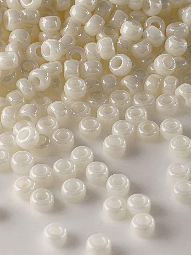 a collection of small, white beads scattered across a surface.