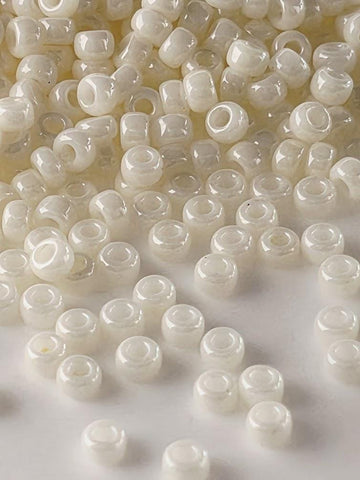 a collection of small, white beads scattered across a surface.