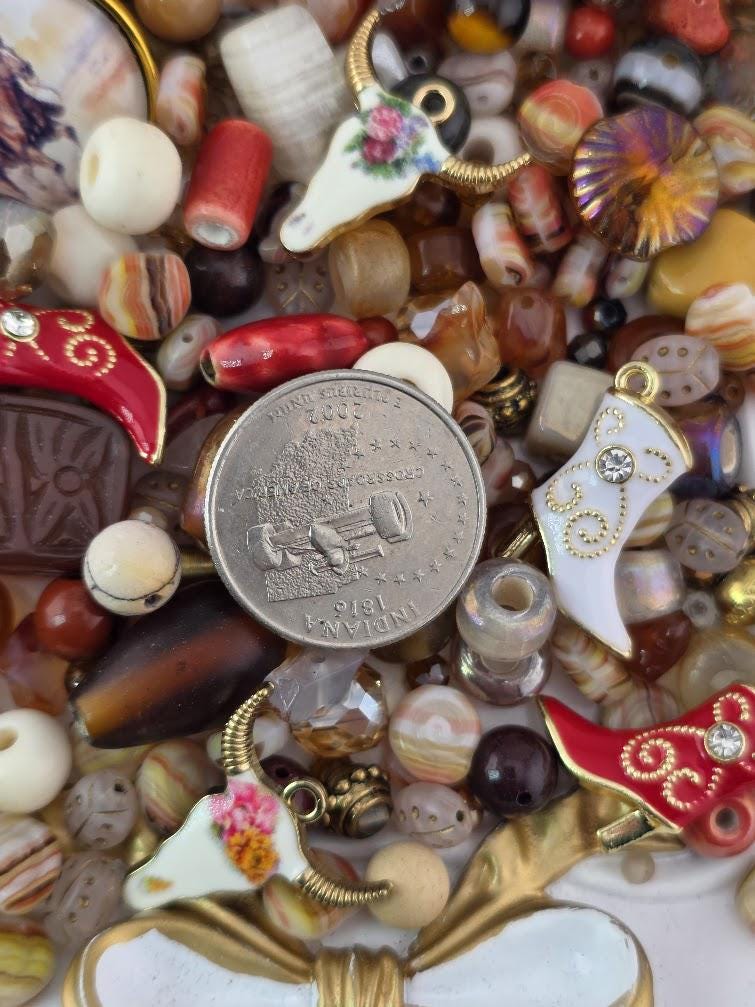 a variety of colorful beads, charms, and coins, creating a visually appealing and diverse collection.