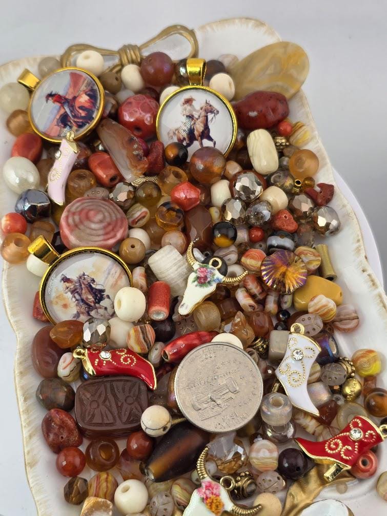 The image is a collection of various beads, coins, and other small items, including a horse and rider, displayed on a white surface.