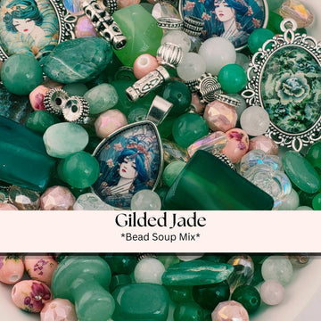 A collection of various beads, charms, and other decorative items, including a pendant with a jade design, arranged in a visually appealing manner.