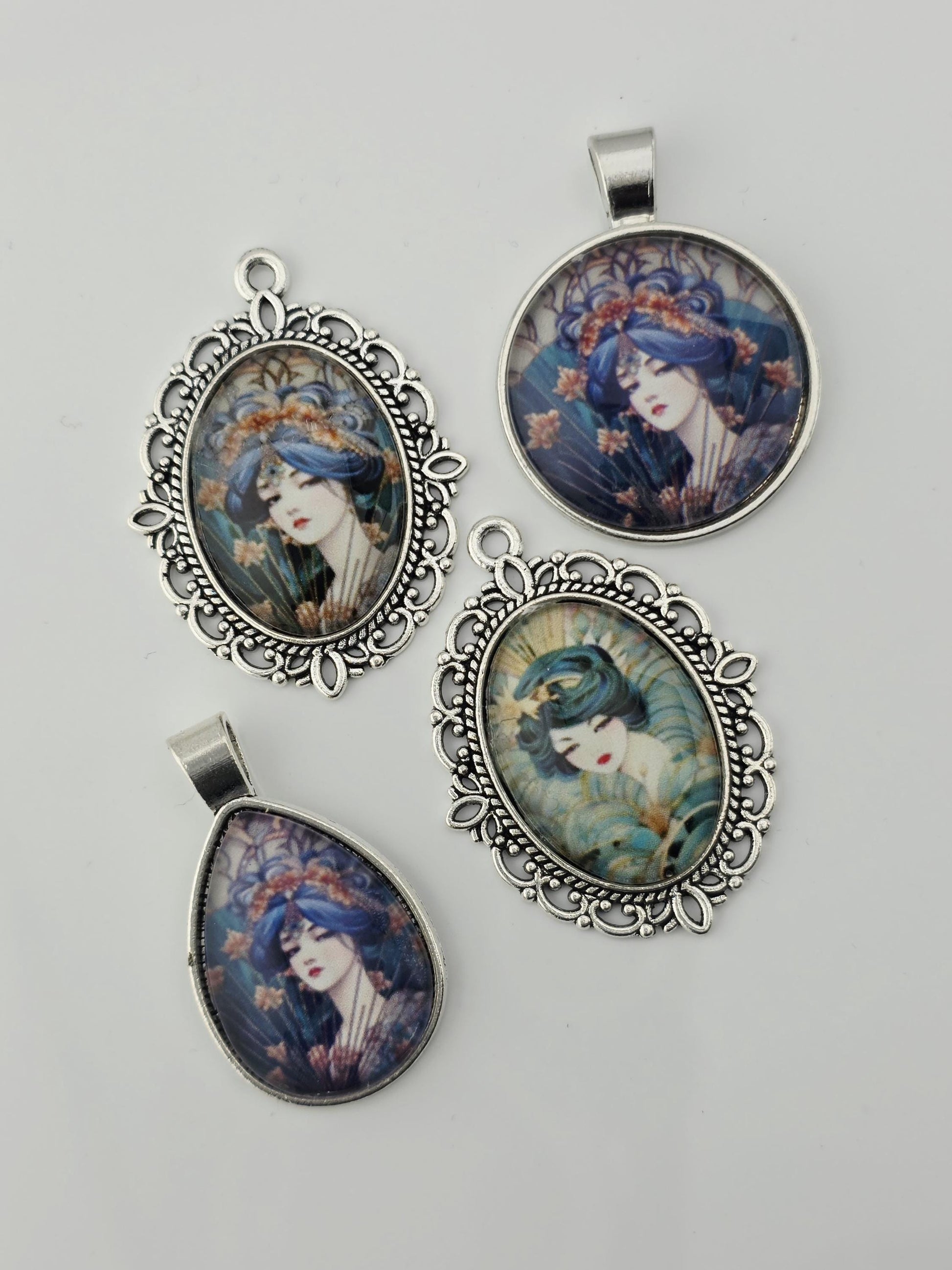 four pendants with floral designs, each featuring a woman's face. The pendants are displayed on a white background, with some of them hanging from metal chains.