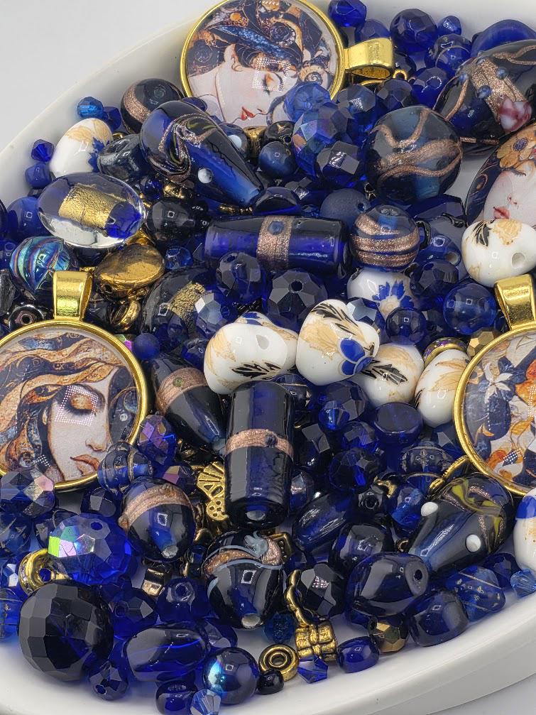 The image is a collection of various blue and gold beads, charms, and pendants, all arranged together in a visually appealing manner.
