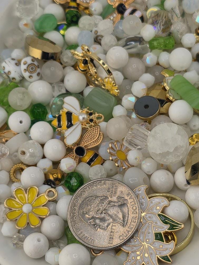 a variety of colorful beads, charms, and coins, creating a visually appealing and diverse collection.