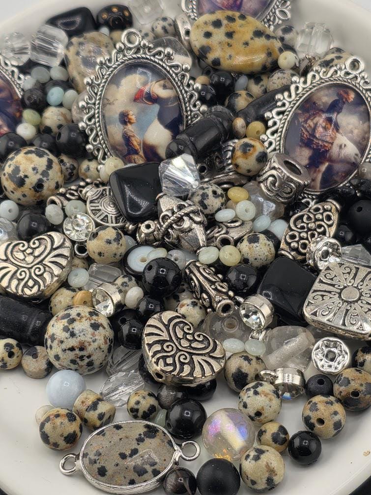 The image is a collection of various beads, charms, and other decorative items, including a horse charm, arranged on a surface.