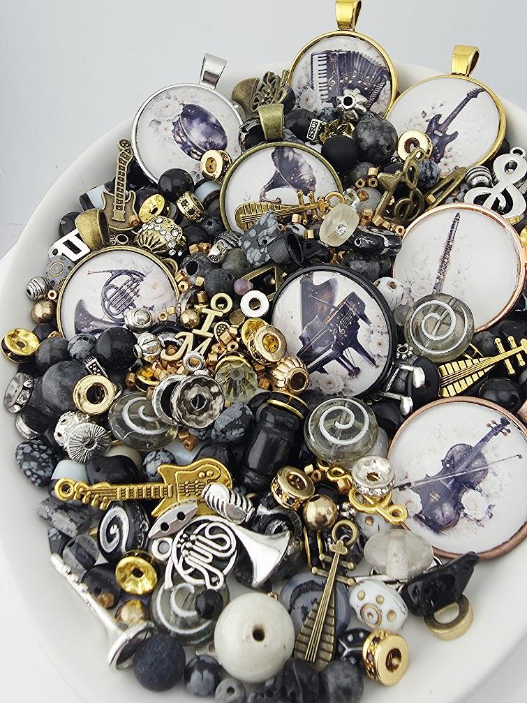 The image is a collage of various musical-themed objects, including charms, beads, and other decorative items, all arranged on a white surface.