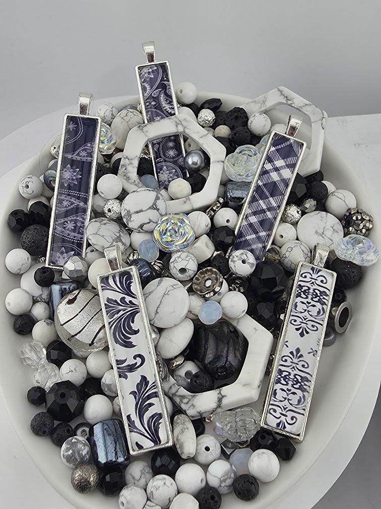 a collection of various decorative elements, including beads, pendants, and other accessories, arranged on a white surface.