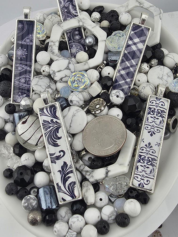 a variety of decorative items, including beads, coins, and pendants, arranged on a white surface.
