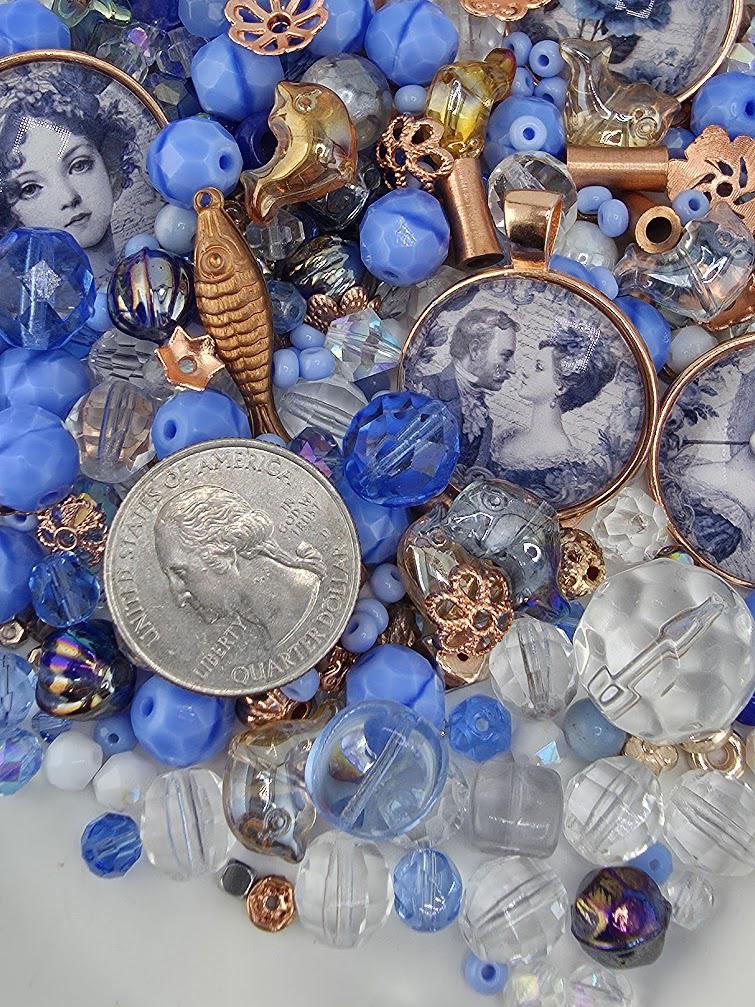 a variety of colorful beads, coins, and other small objects, including a silver coin, arranged in a visually appealing manner.